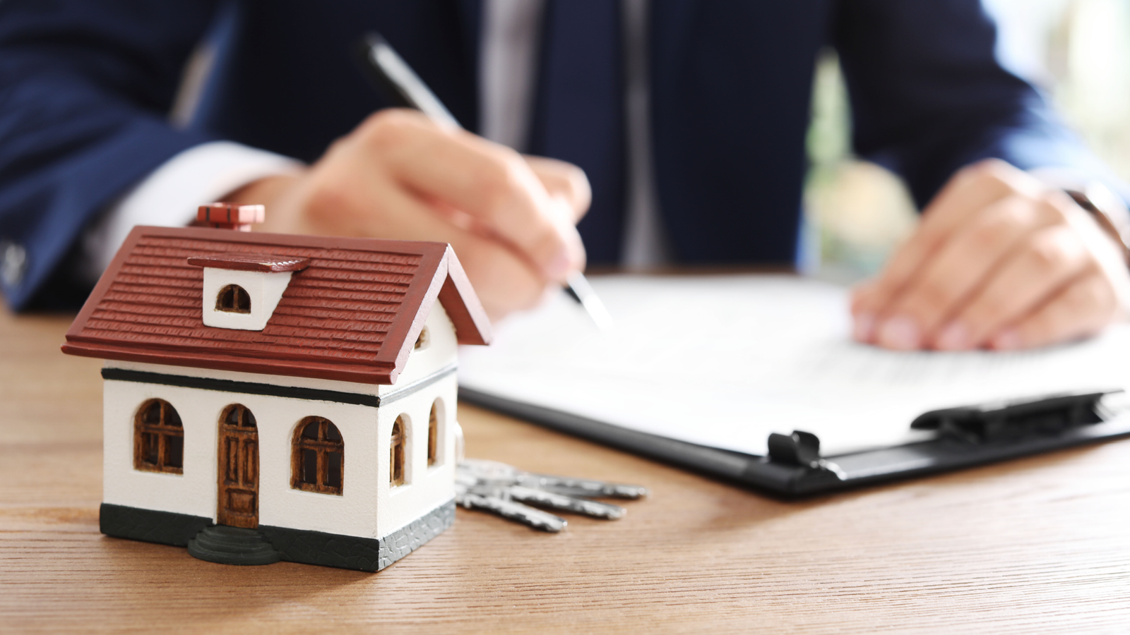 Couple at a real estate closing signing documents